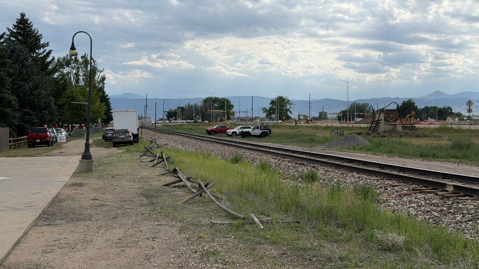 The transportation corridor along Niwot's western edge — a path beside the rail line, the foothills beyond.