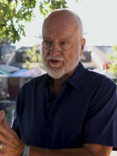 Tony Santelli, in downtown Niwot with the storefronts behind him.